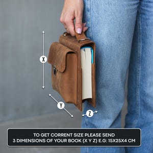 May include: A brown leather book bag with a flap closure and a handle. The bag is designed to hold a book, and the image shows the dimensions to measure your book to ensure a proper fit.  To get the correct size, please send 3 dimensions of your book (X Y Z) E.G: 15X25X4 CM