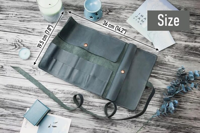 May include: A teal blue leather roll-up case with multiple slots for holding tools or supplies. The case measures 14.2 inches by 7.8 inches.