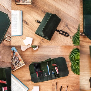 May include: A dark green leather roll-up case with multiple compartments for holding art supplies, such as pencils, brushes, and markers. The case has a metal clasp and a strap for carrying.