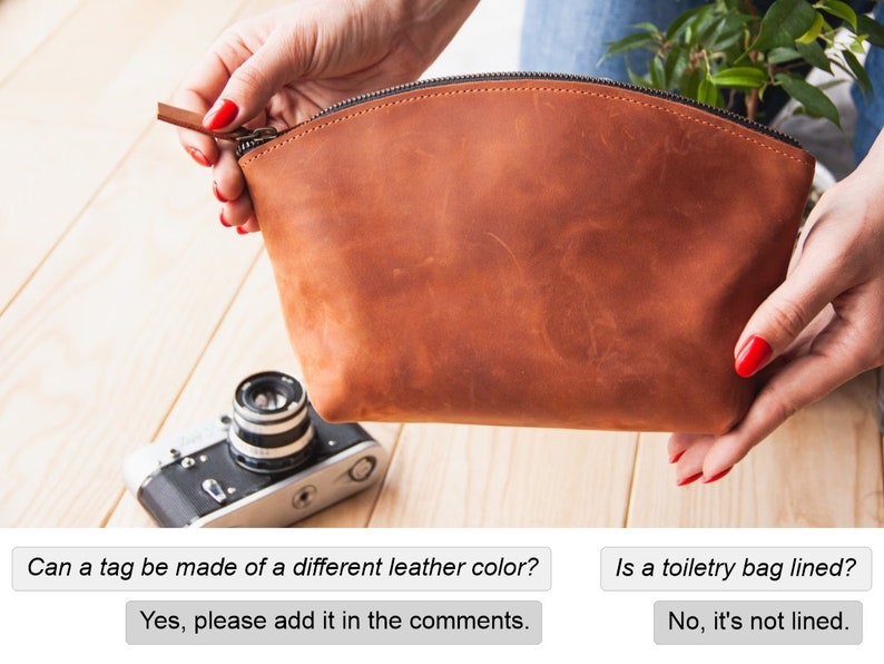 May include: A brown leather toiletry bag with a zipper closure. The bag is being held open by a hand with red nail polish.