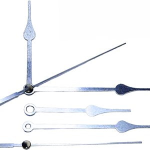 May include: A selection of silver clock hands in different designs. The set includes hour, minute, and second hands, each with unique decorative ends. These hands are suitable for clock repair or crafting.