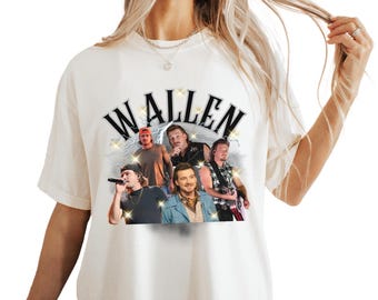 May include: Cream-colored t-shirt featuring the name "WALLEN" in a black, stylized font with a starburst design. Below the text are images of five men. The shirt is a casual, short-sleeved style.
