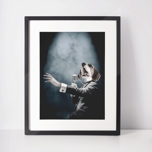 May include: A framed print of a dog wearing a suit and singing into a microphone. The dog is on a stage with smoke behind it.