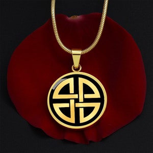 May include: A gold chain necklace with a round pendant featuring a black and gold Celtic knot design.