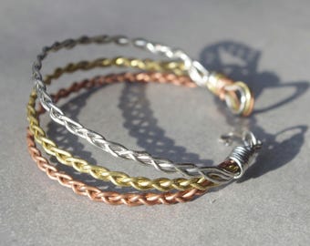 Mulitmetal copper brass steel wrapped braided wire bracelet. Tripple braid style unique pattern.