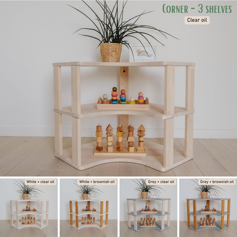 May include: A three-tiered corner shelf unit made of light-colored wood. The shelves are curved and hold wooden toys and a small plant in a woven basket. The text "CORNER - 3 SHELVES" and "Clear oil" are visible.
