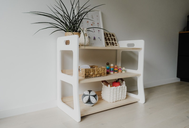 Scandinavian-style open, 3-shelf, solid wood Montessori shelf. The sides are painted white, the middle shelves are light wood, oiled with clear oil. Perfectly compatible with our Montessori bookshelves - same height and depth.