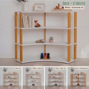 May include: A white and wood-toned arched bookshelf with four shelves. The frame is made of light-colored wood, and the shelves are white. The text "ARCH - 4 SHELVES" is visible. The bookshelf is filled with books and decorative items.