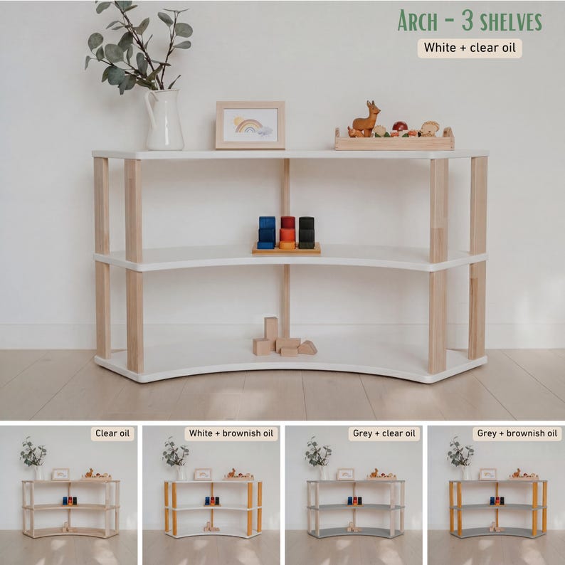 May include: A white wooden arch-shaped shelf unit with three shelves and natural wood supports. The text "ARCH - 3 SHELVES" and "White + clear oil" is visible. The shelf is empty, with a few toys on the top shelf.
