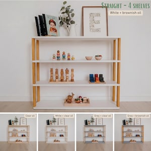 May include: A white and brown wooden bookshelf with four shelves. The frame is brown, and the shelves are white. The top shelf holds books, a framed print, and a vase with greenery. The text "STRAIGHT - 4 SHELVES White + brownish oil" is visible.