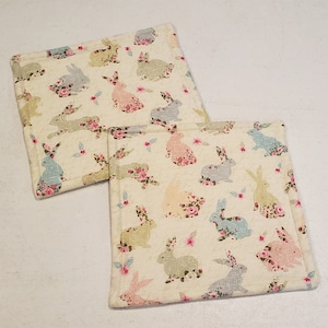 Easter bunnies on elegant beige background potholder set of 2