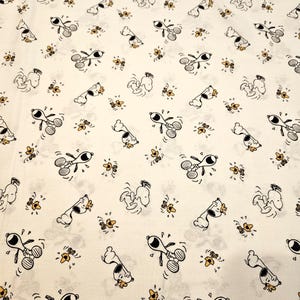Peanuts Snoopy and Woodstock playing on white background material is sold by the yard and is 100% cotton