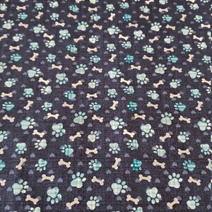 Dog Bones and Paws on Blue Background by the yard and is 100% cotton
