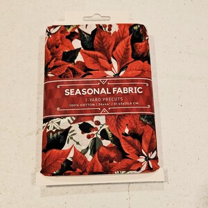 Christmas Red Poinsettia material is sold by the yard and is 100% cotton fabric