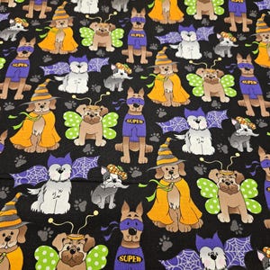 Halloween Dogs in costume on black background material is sold by the yard and is 100% cotton