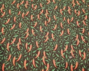 Chili Peppers on black material is sold by the yard and is 100% cotton fabric