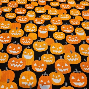 Halloween Glow in the dark material Pumpkins on black background FLANNEL material is sold by the yard and is 100% cotton