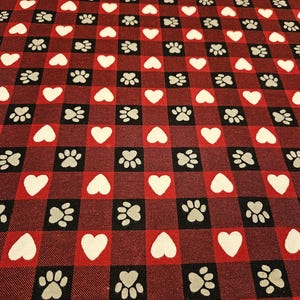 Dog Paws and hearts on buffalo check FLANNEL fabric is sold by the yard and is 100% cotton