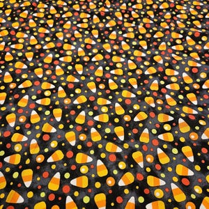 Candy Corn on black material; 1 yard pieces sold individually; 100% cotton