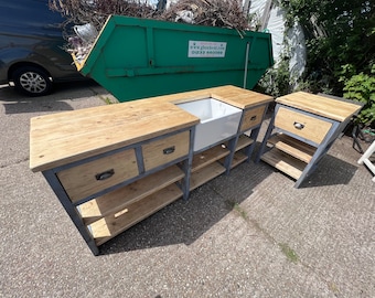 May include: A rustic kitchen island with a farmhouse sink, two drawers, and open shelving. The island is made of reclaimed wood and metal.
