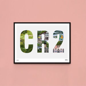 May include: A white framed print with a black border featuring a graphic design of the letters CR2. The letters are made up of images of buildings, parks, and other landmarks in South Croydon, England. The text "South Croydon" and "Purley Oaks" are visible in the image.