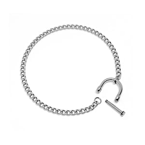 May include: A silver chain bracelet with a hook clasp. The bracelet is made of a simple chain link design.