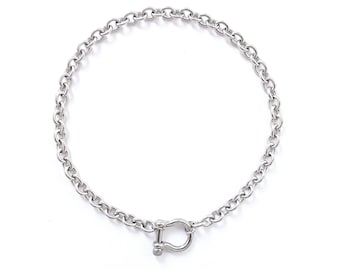 May include: A silver chain necklace with a silver U-shaped clasp.