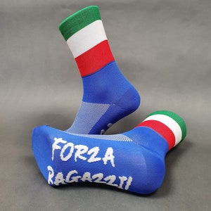 May include: A pair of blue socks with the Italian flag on the top and the words "FORZA RAGAZZI" on the bottom.