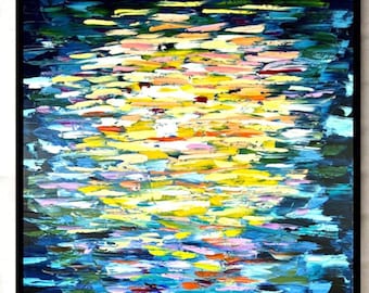 May include: Abstract painting with a blue, yellow, and white color scheme. The painting is framed in black and hangs on a white brick wall.