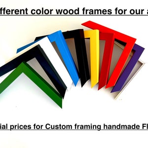 May include: A collection of colorful wood picture frames in various colors, including green, navy, white, blue, black, yellow, red, and purple. The text at the top says "Different color wood frames for our art".