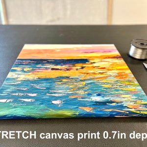May include: A colorful abstract painting of a seascape with a sunset in the background. The painting is on a stretched canvas with a 0.7 inch depth.