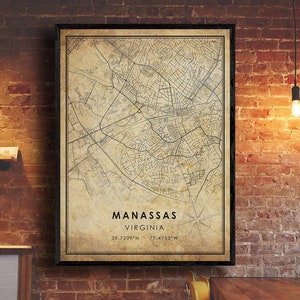 May include: A vintage-style map print of Manassas, Virginia, with a black frame and a beige background. The map shows the city's streets and landmarks. The text "Manassas, Virginia, 38.7509°N, 77.4753°W" is printed at the bottom of the map.
