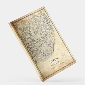 May include: Vintage style map print of Lisbon, Portugal with a compass rose and the coordinates 38.7223&deg; N - 9.1393&deg; W. The map is printed on a textured, beige background.