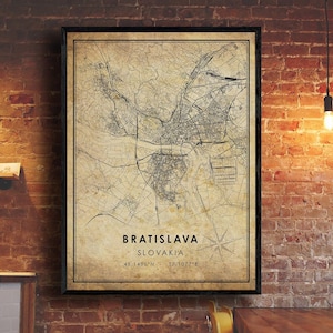 May include: A vintage-style map print of Bratislava, Slovakia. The map is in black and white with a beige background. The city name and coordinates are printed at the bottom of the map.