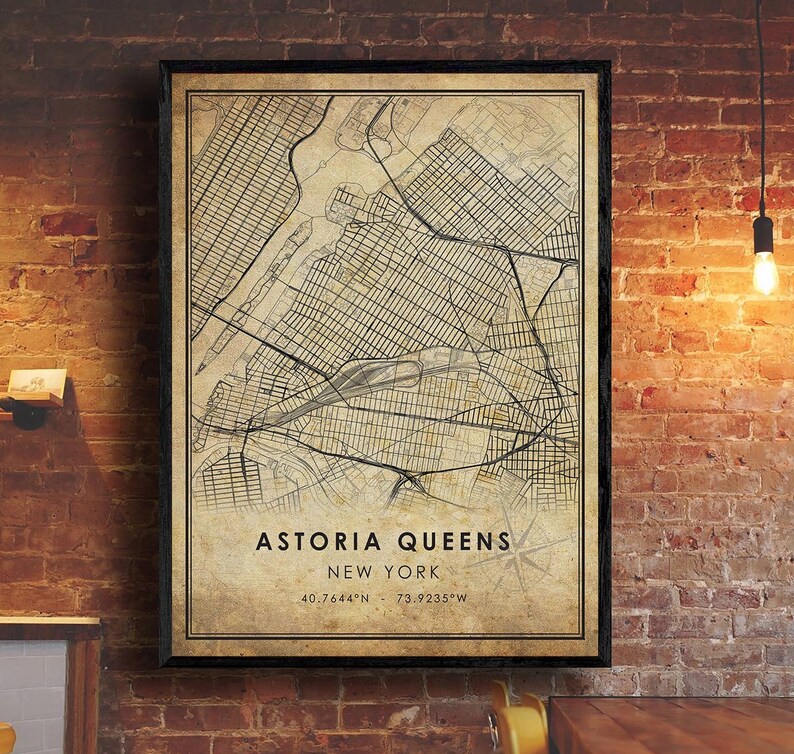 May include: A vintage-style map print of Astoria, Queens, New York City. The map is in black and white with a beige background and features street grids and landmarks. The text "Astoria Queens New York 40.7644&deg;N 73.9235&deg;W" is printed at the bottom of the map.