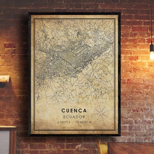 May include: A vintage-style map print of Cuenca, Ecuador. The map is in black and white with a beige background. The city name and coordinates are printed at the bottom of the map.