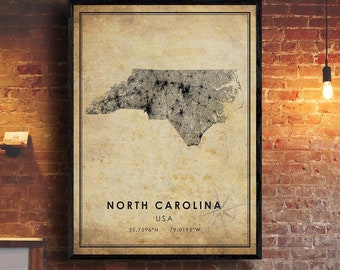 May include: A vintage-style map print of North Carolina, USA. The map is in black and white and shows the state's outline and major cities. The print has a distressed, aged look and includes the coordinates 35.7596°N 79.0193°W.