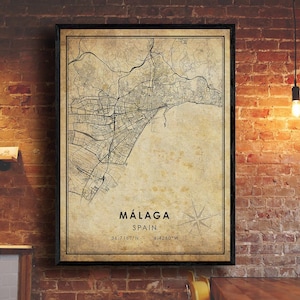 May include: A vintage-style map of Málaga, Spain, with a compass rose and the coordinates 36.7167°N, 4.4260°W. The map is printed on a beige background with a distressed, aged look.