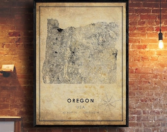 May include: Framed vintage-style map of Oregon, USA, with coordinates and a compass rose. The map is in shades of gray and beige, set against a dark frame. The background is a brick wall.