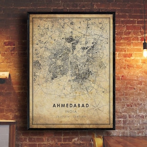 May include: A vintage-style map print of Ahmedabad, India. The map is in black and white and features a compass rose and the city's coordinates: 23.0225°N 72.5714°E.