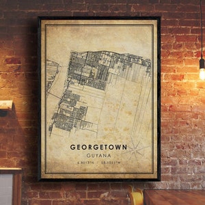 May include: A vintage style map print of Georgetown, Guyana. The map is in black and white and shows the city streets and landmarks. The text "GEORGETOWN GUYANA 6.8013°N - 58.1551°W" is printed at the bottom of the map.