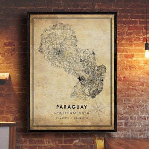 May include: A vintage-style map of Paraguay, South America, with a compass rose and the coordinates 23.4425°S, 58.4438°W. The map is printed on a beige background with black lines and text.