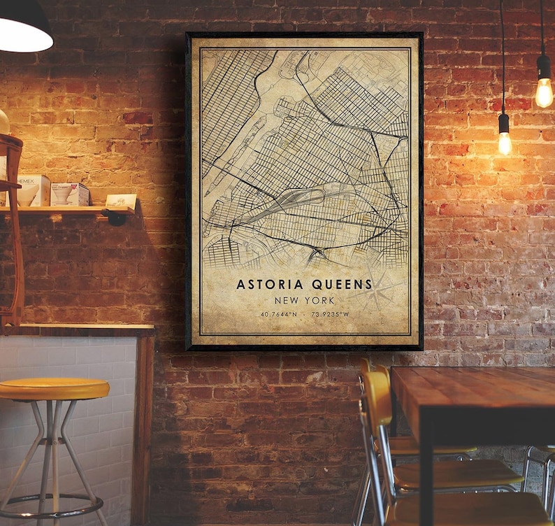 May include: A vintage-style map print of Astoria, Queens, New York City. The map is printed on a beige background with black lines and text. The text at the bottom reads "Astoria Queens, New York, 40.7644&deg;N, 73.9235&deg;W".