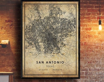 May include: A vintage-style map print of San Antonio, Texas. The map is in black and white with a beige background. The city name and coordinates are printed at the bottom of the map.