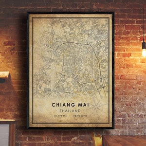 May include: A vintage style map print of Chiang Mai, Thailand. The map is in black and white with a beige background. The city name and coordinates are printed at the bottom of the map.