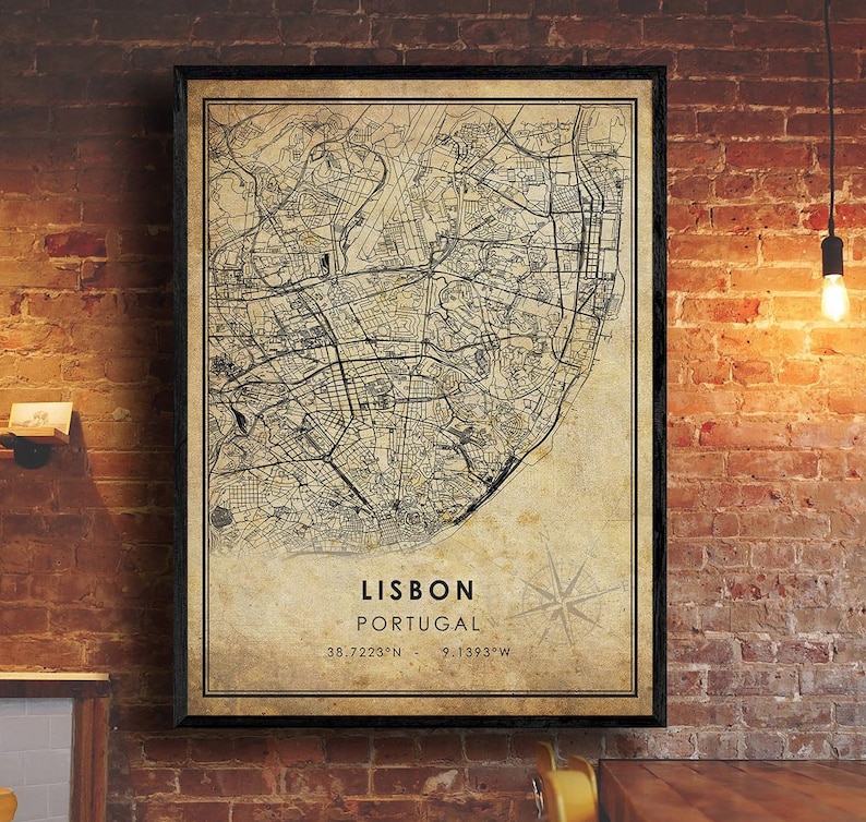 May include: A vintage-style map of Lisbon, Portugal, with a compass rose and the coordinates 38.7223&deg;N, 9.1393&deg;W. The map is printed on a beige background with black lines and text.