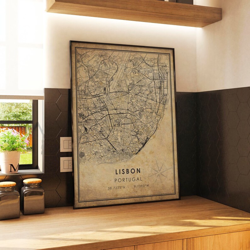 May include: A vintage-style map print of Lisbon, Portugal, with a compass rose and the coordinates 38.7229&deg;N, 9.1393&deg;W. The map is printed on a beige background with black lines and text.