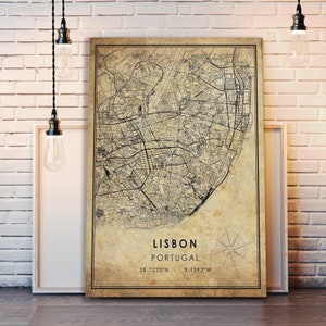 May include: A vintage-style map of Lisbon, Portugal, with a compass rose and the coordinates 38.7223&deg;N - 9.1393&deg;W. The map is printed on a beige background with black lines.
