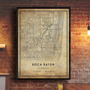May include: A vintage-style map print of Boca Raton, Florida. The map is in black and white with a beige background. The city name and coordinates are printed at the bottom of the map.