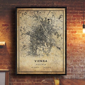 May include: A vintage-style map print of Vienna, Austria. The map is in black and white and shows the city's streets and landmarks. The text "Vienna, Austria" and the coordinates "48.2082°N 16.3738°E" are printed at the bottom of the map.